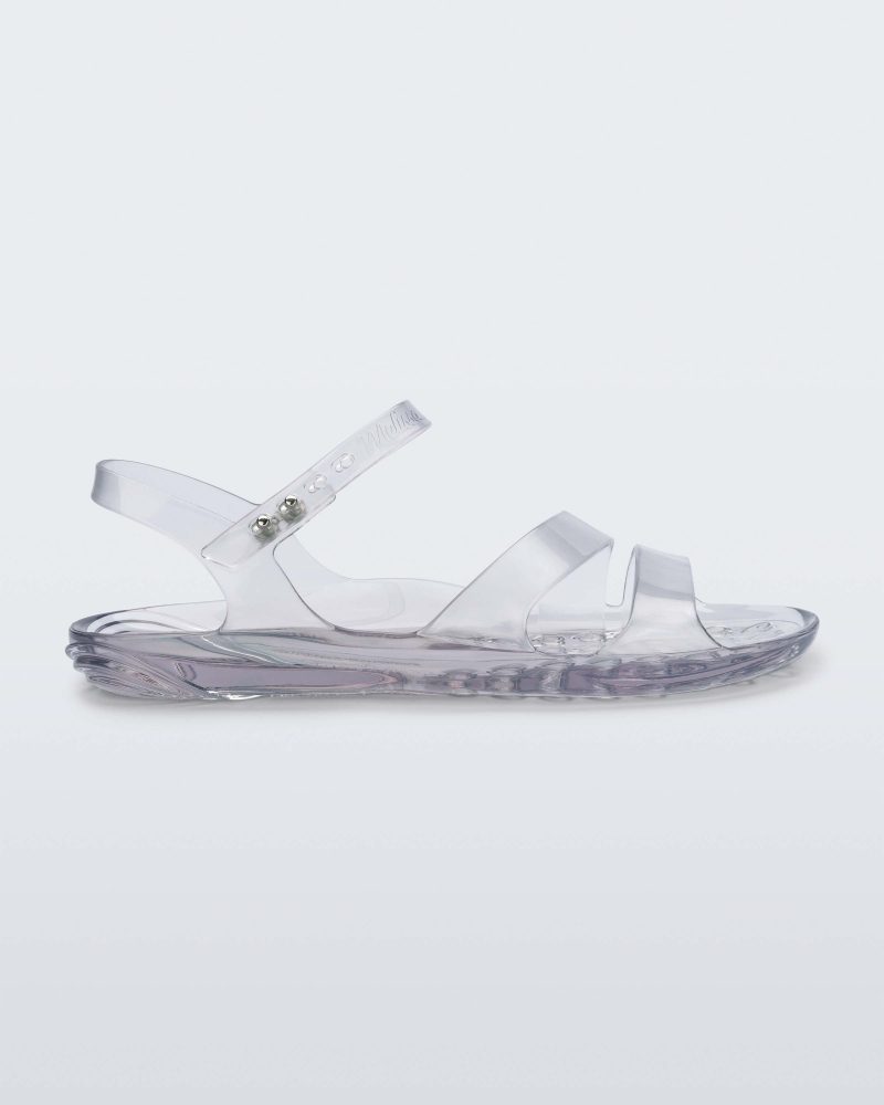 Side view of a clear Melissa Real Jelly Sandal with two front straps and an ankle strap.