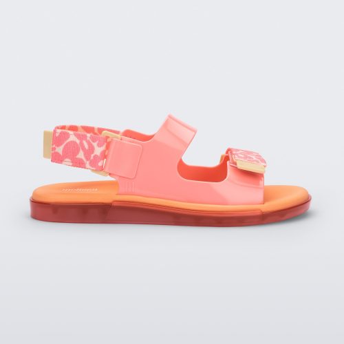 Side view of a pink Melissa Brave Papete sandals with an orange insole, pink flower print, pink straps and a velcro back.