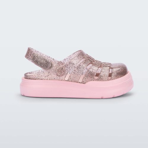 Side view of a pink/glitter Mini Melissa Sunday sandal with a glitter base, closed toe front and pink sole.