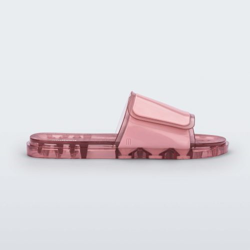 Side view of a pink Melissa Brave Slide with a pink velcro top strap and translucent pink insole.