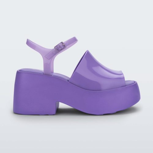 Side view of a lilac Melissa Pose platform sandal with a lilac front strap, a clear lilac ankle strap and a lilac sole.