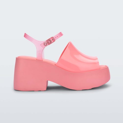 Side view of a pink Melissa Pose platform sandal with a pink front strap, a clear pink ankle strap and a pink sole.