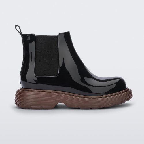 Side view of a Melissa Step slip on ankle boot with bronze sole and black upper.