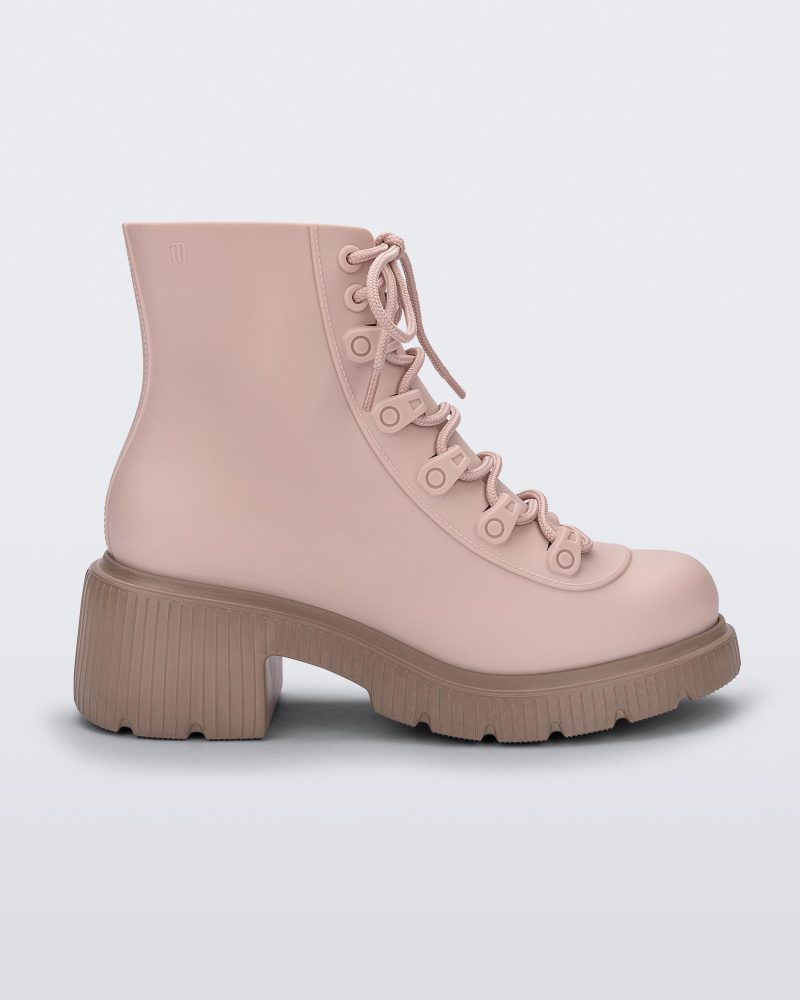 Side view of a pair of brown/pink Melissa Cosmo boots with a pink base, laces and a brown heel sole, laying on their side.