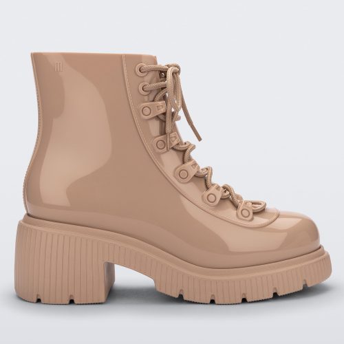 Side view of a beige Melissa Cosmo boot.