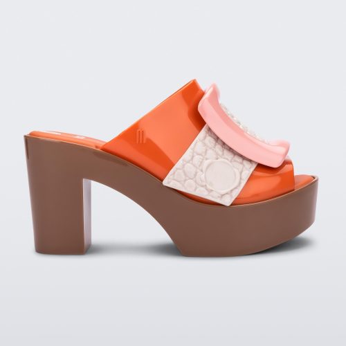 Side view of orange/brown Melissa Buckle Up heeled mule with ivory strap and pink buckle.