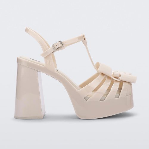 Side view of a Melissa Tie Party platform heel sandal in Beige with ankle strap and buckle closure and 3D bow detail on front straps