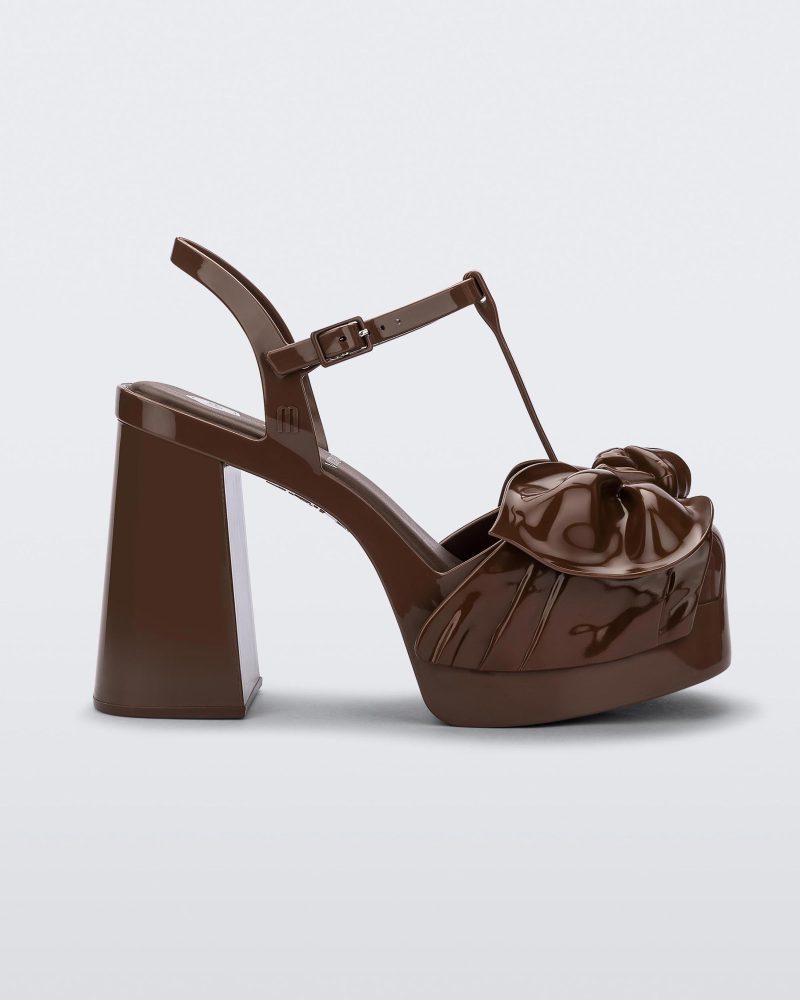 Side view of a Melissa Tie Party platform heel in brown with 3D bow detail and ankle strap with buckle.