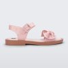 Side view of a Melissa Tie Mar sandal with beige sole, pink ankle straps with buckle closure and pink 3D bow detail on front straps