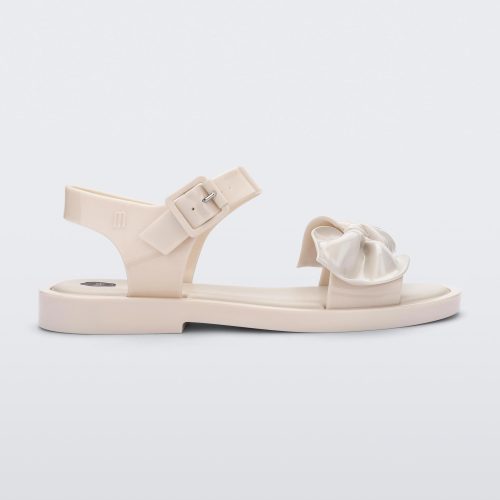 Side view of a Beige/Beige Melissa Tie Mar Sandal with a beige base, an ankle strap and a front strap with a beige bow on the front.