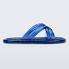 Side view of a transparent blue Melissa Cali slide with cross straps.