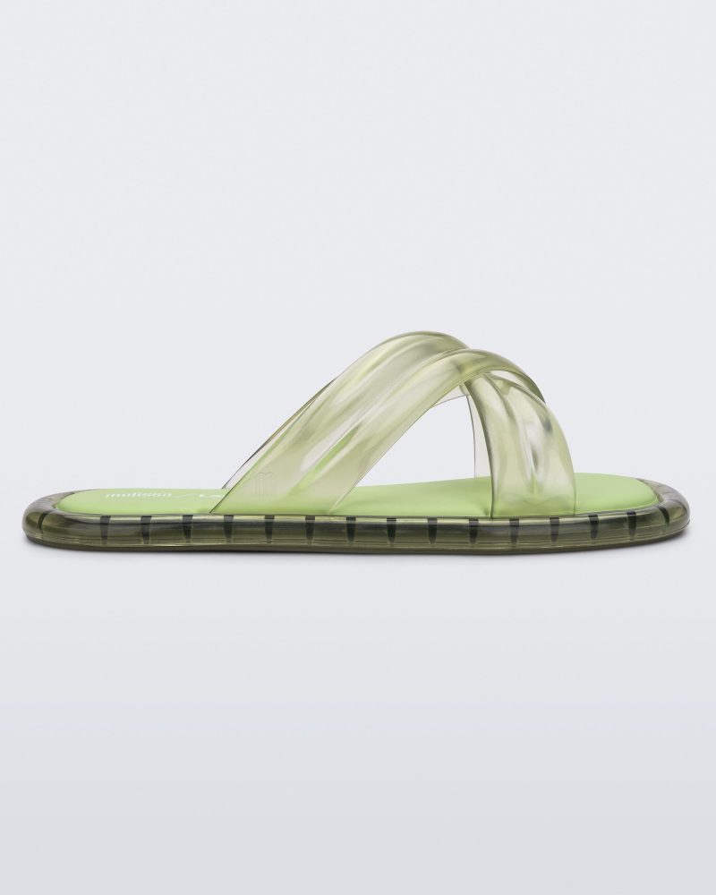 Side view of transparent green Melissa Cali slides with cross straps.