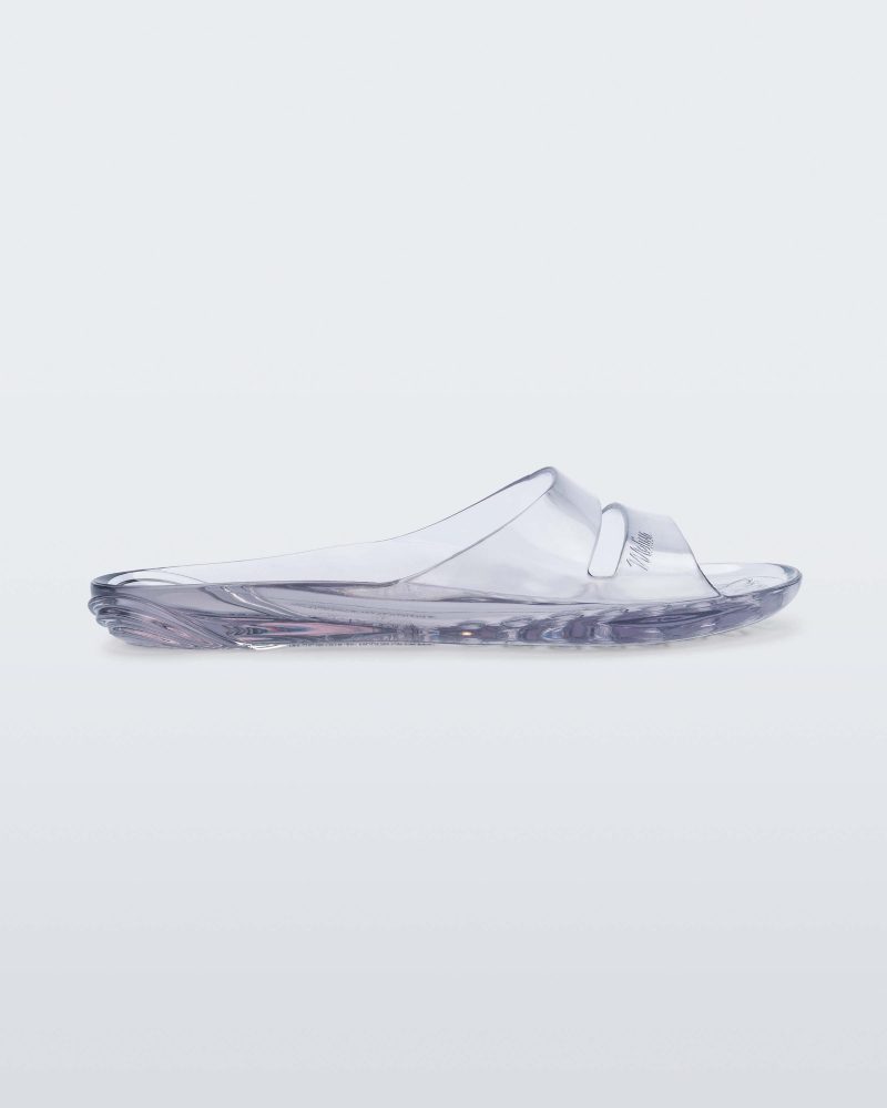 Side view of a clear Melissa Real Jelly Slide with two front straps.