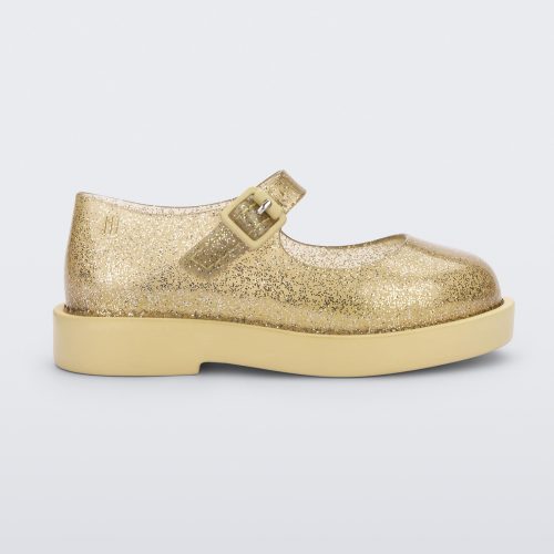 Side view of a pair of clear glitter yellow Mini Melissa Lola loafer with a rounded toe, strap and yellow buckle.