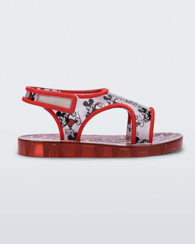 Side view of red Mini Melissa Acqua sandal with a Mickey Mouse print.