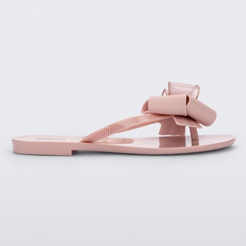 Side view of a light pink Melissa Harmonic Sweet flip flop with a light pink and glitter bow.