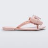 Side view of a light pink Mini Melissa Harmonic Sweet flip flop with a light pink and glitter bow.