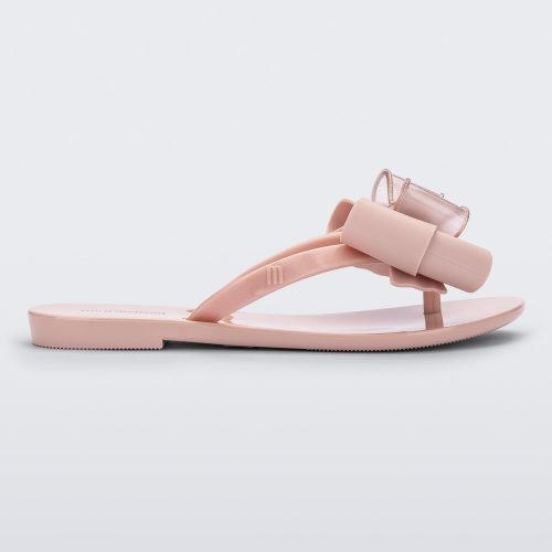 Side view of a light pink Mini Melissa Harmonic Sweet flip flop with a light pink and glitter bow.