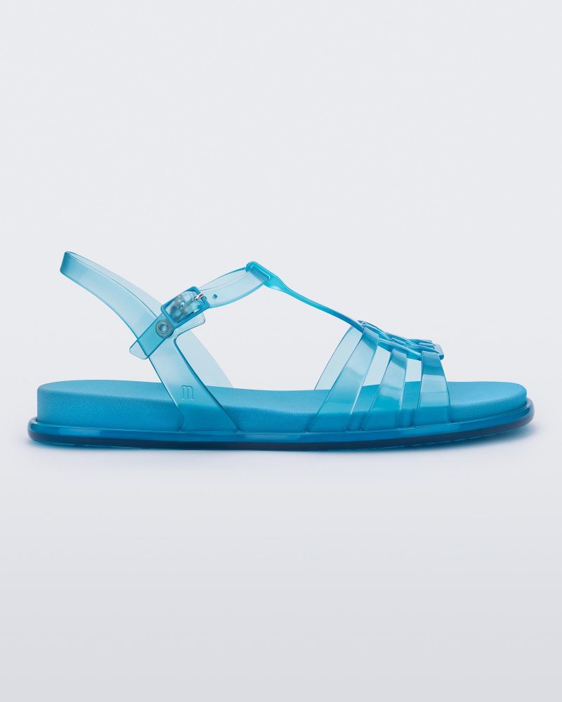 Side view of a Melissa Party sandal in transparent blue with back ankle strap and buckle closure