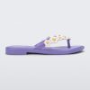 Side view of a lilac / white Melissa Spring Flip Flop with yellow and white flowers on them.