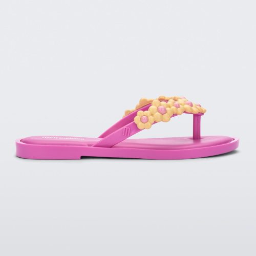 Side view of a pink Mini Melissa Spring Flip Flop with yellow and pink flowers.