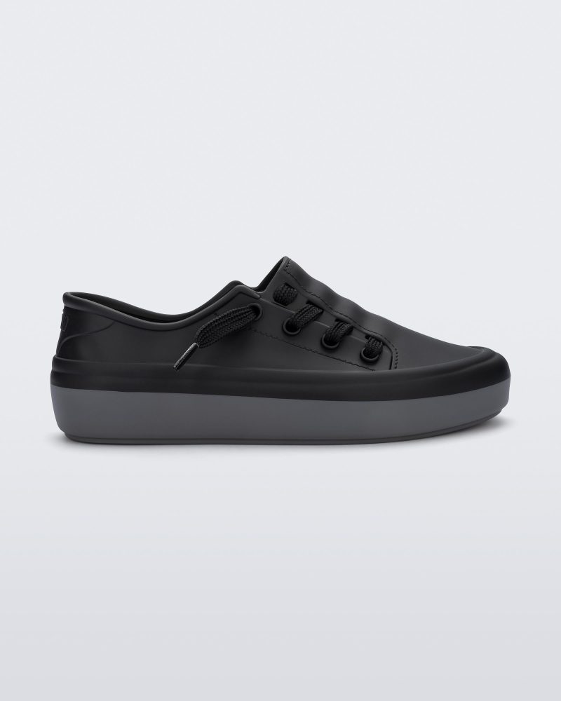 Side view of a black Melissa Ulitsa sneaker with a black base, laces and a gray sole.