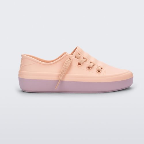 Side view of a pink Melissa Ulitsa sneaker with a pink base and laces.