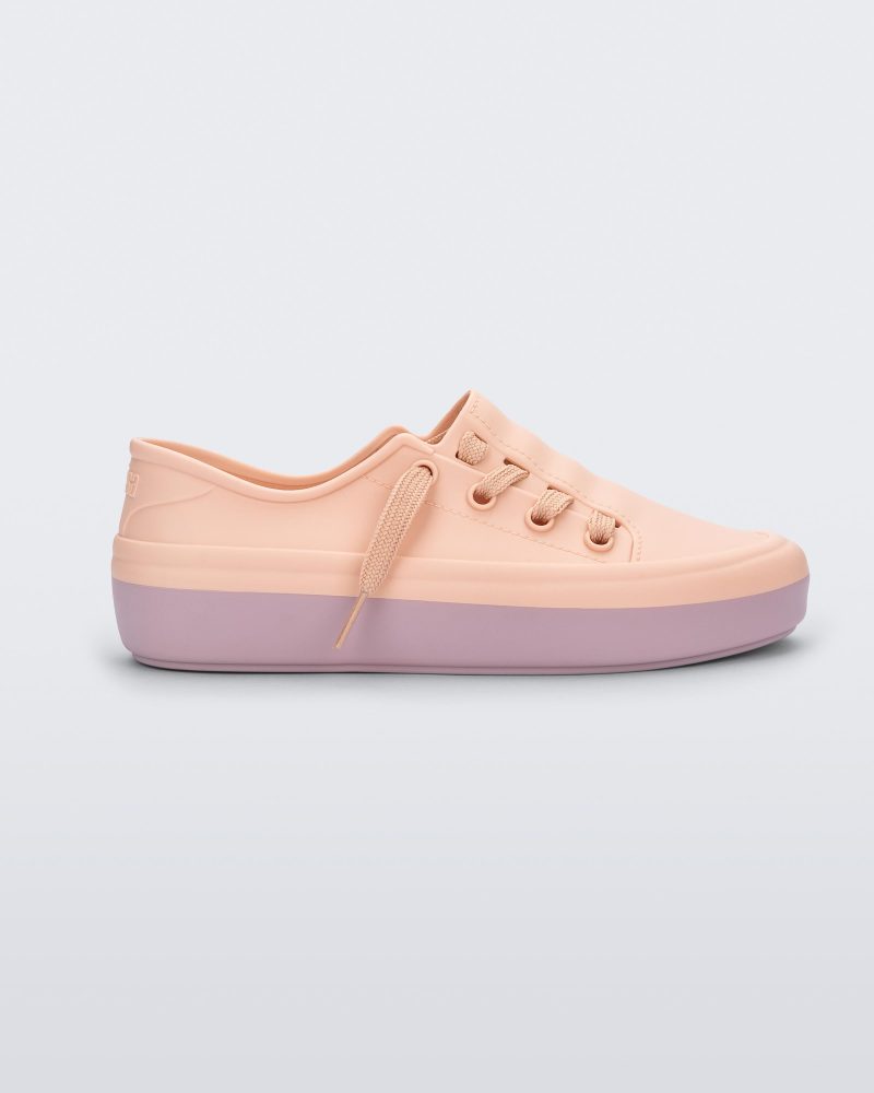 Side view of a pink Melissa Ulitsa sneaker with a pink base and laces.