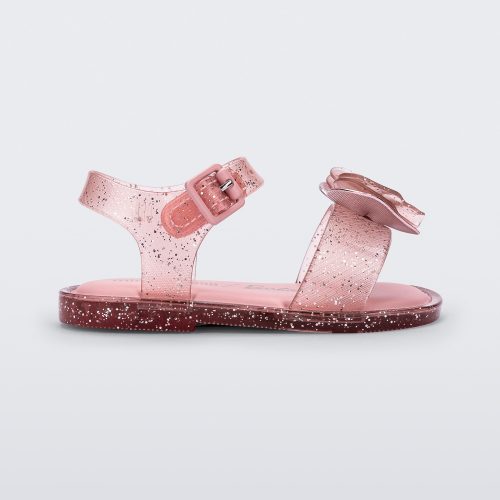 Side view of a pink glitter Mini Melissa Mar Sandal with a pink heart shaped bow and buckle.