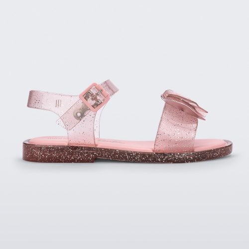 Side view of a glitter pink Mini Melissa Mar Sandal with a bow.