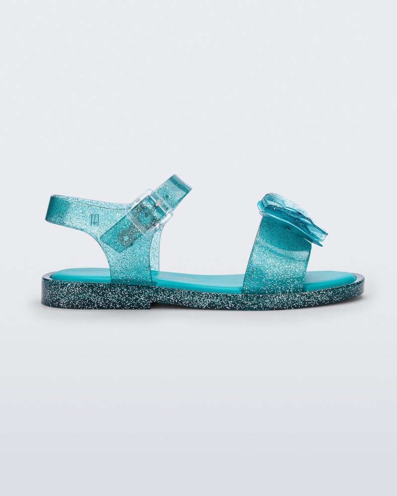 Side view of a glitter blue Mini Melissa Mar Sandal with a bow.