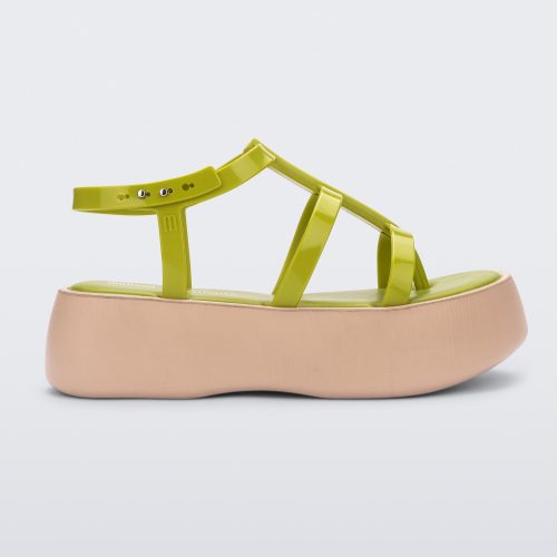 Side view of a beige/green Melissa Caribe High Platform sandal with two green front straps joined by a vertical strap intersecting the ankle strap and a beige sole.