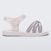 Side view of a white/silver Mini Melissa Precious sandal with three silver glitter front straps joining in the middle and a white ankle strap.