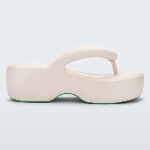 Side view of a beige Melissa Free Platform flip flop with puffer-like straps.