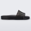 Side view of a transparent black Melissa Court Slide with a checkered pattern texture.