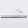 Side view of a clear/white Melissa Court Slide with a checkered pattern texture.