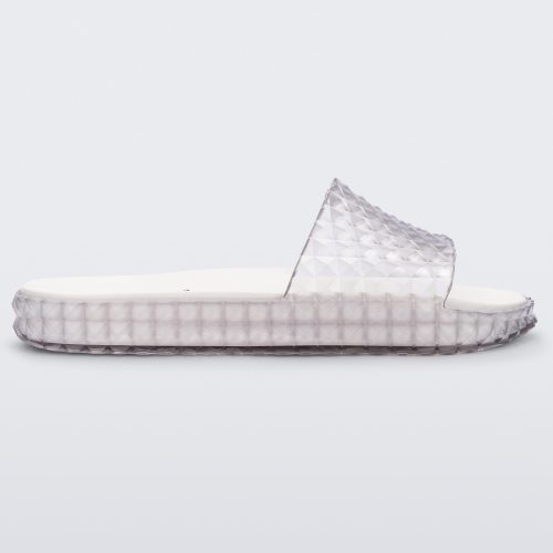 Side view of a clear/white Melissa Court Slide with a checkered pattern texture.