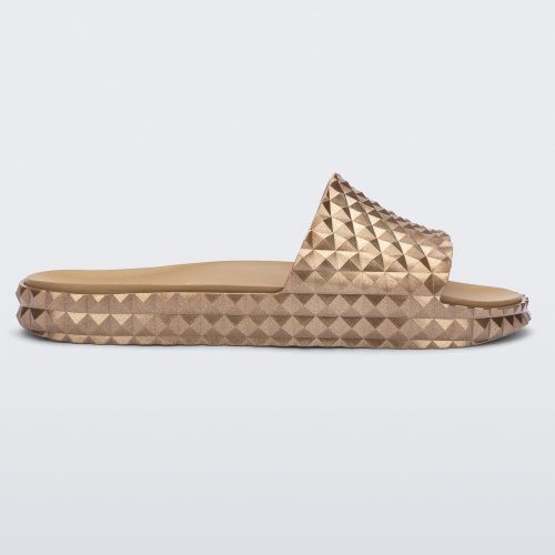 Side view of a gold Melissa Court Slide with a checkered pattern texture.