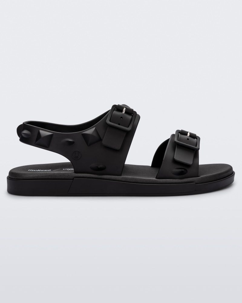 Side view of a black Melissa Spikes Sandal with two straps with buckles on top and spike details around the base.