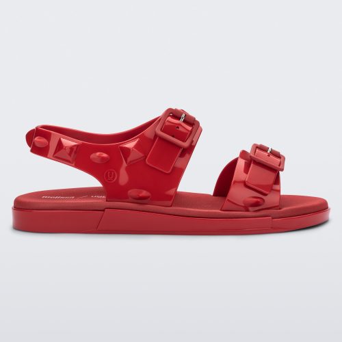 Side view of a red Melissa Spikes Sandal with two straps with buckles on top and spike details around the base.