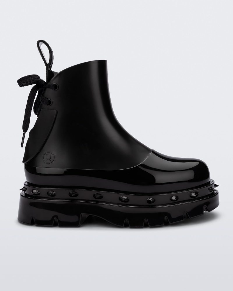 Side view of a black Melissa Spikes Boot with spike details around the sole and laces in the back.