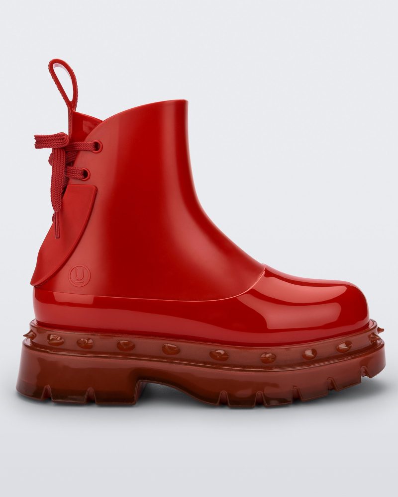 Side view of a red Melissa Spikes Boot with spike details around the sole and laces in the back.