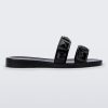 Side view of a black Melissa Lucy slide with stud details on the two straps.