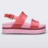 Side view of a transparent red/pink Melissa Cosmic platform sandals with a pink sole and two red straps.