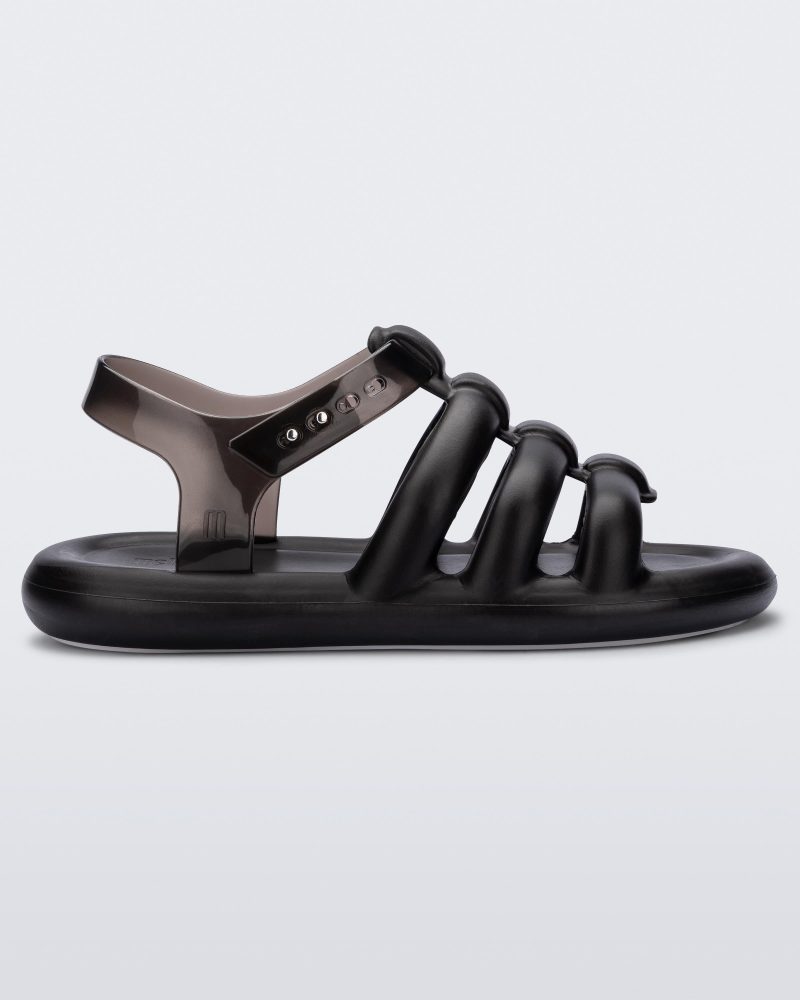 Side view of a black Melissa Freesherman sandal with black and clear straps.