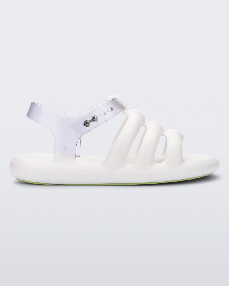 Side view of a white Melissa Freesherman sandal with white and clear straps.