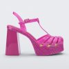 Side view of a glitter pink Melissa Party Heel with several straps and a closed toe front.