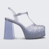 Side view of a glitter clear Melissa Party Heel with several straps and a closed toe front.