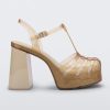 Side view of a beige glitter gold Melissa Party platform heel.