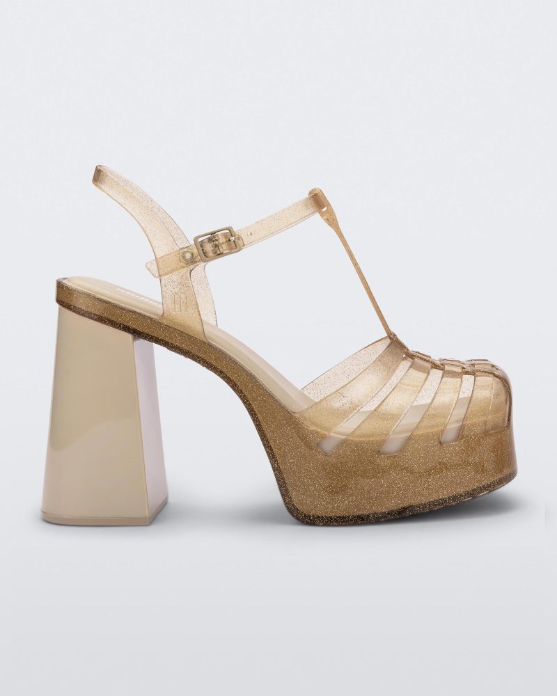 Side view of a beige glitter gold Melissa Party platform heel.